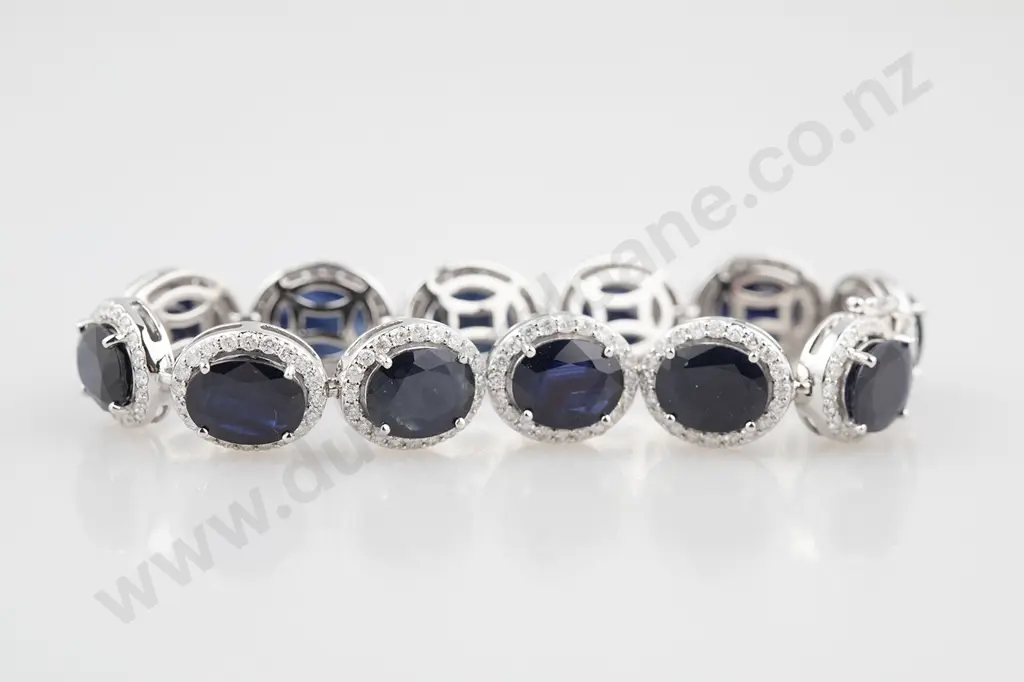 14ct White Gold Sapphire and Diamond Bracelet 12 oval cut dark royal blue sapphires approx 32.94cts tsw Image 1++