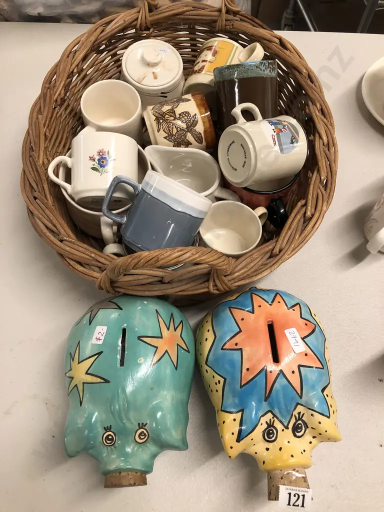 Two Piggy Banks and Basket of NZ Mugs Image 1++