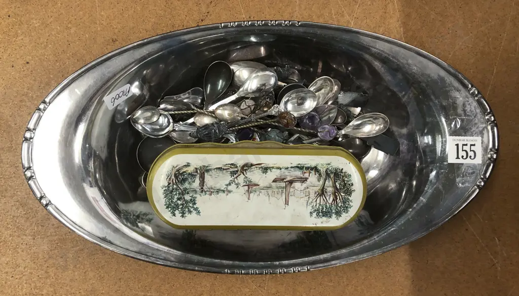 Plated Bowl With Assorted Spoons and Tin Image 1++