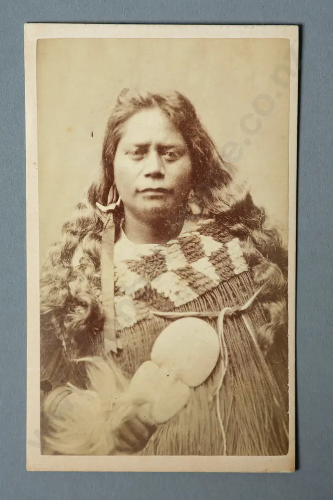 Thomas Edward Price Portrait of a Maori woman wearing a korowai holding a kotiate paraoa (whalebone hand club) Carte de visite albumen print Image 1++