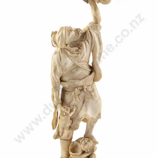 A Japanese Meiji Period Ivory figure of a Bearded Sennin in Battle with Three Oni