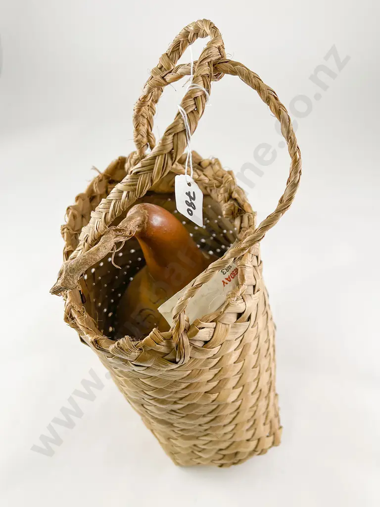Gourd with carved decoration in a woven muka basket Image 1++