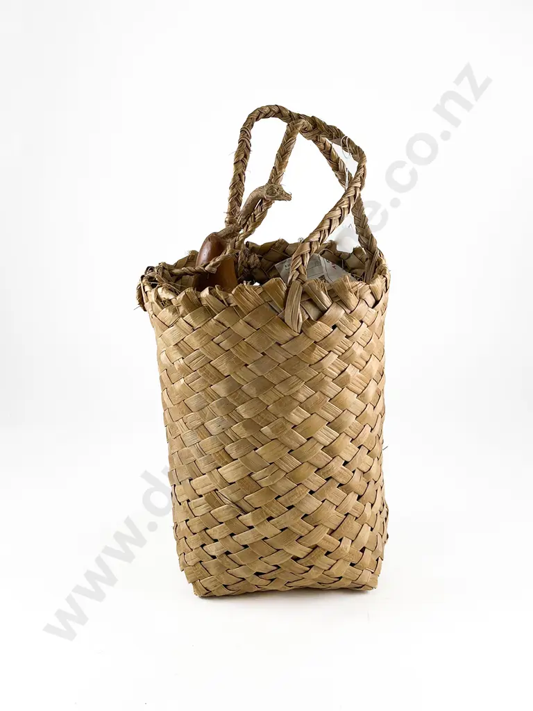 Gourd with carved decoration in a woven muka basket Image 1++