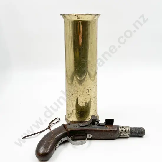 Brass Artillery Shell Together with Toy Pistol
