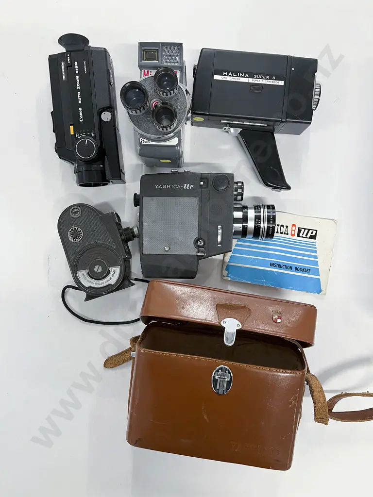 Five Movie Cameras Including Bill & Howell Filmo and Miracon II Image 1++