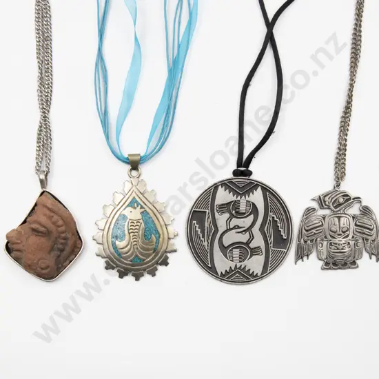 Four South American Silver and Metal Pendants