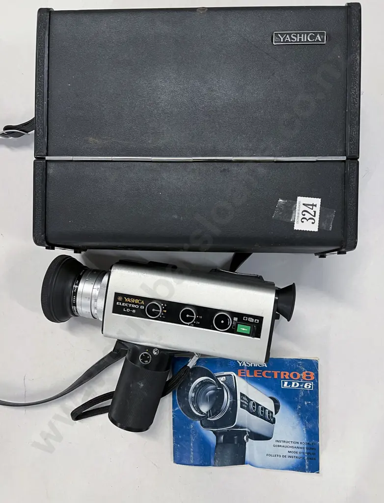 Two Hand-Held Movie Cameras Image 1++