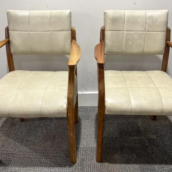 Two Mid Century Style Vinyl Upholstered Arm Chairs