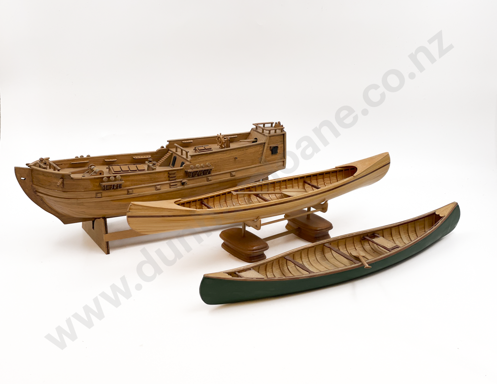 Two Wooden Canoes Together with Model Ship Image 1++