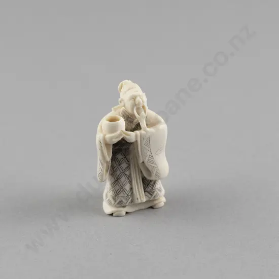 Signed Ivory Netsuke of a Standing Sage holding a Cup