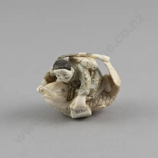 Signed and Stained Ivory Netsuke of an Immortal Kinko Riding a Giant Fish