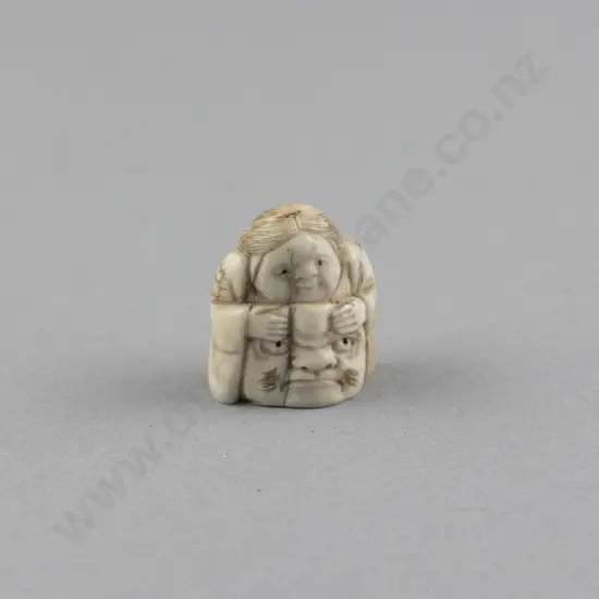 Ivory Netsuke of a Actor resting on his Mask