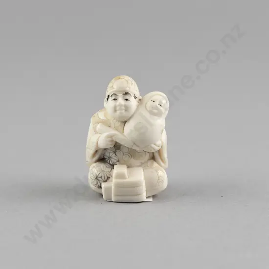 Signed Ivory Netsuke of a Doll Maker
