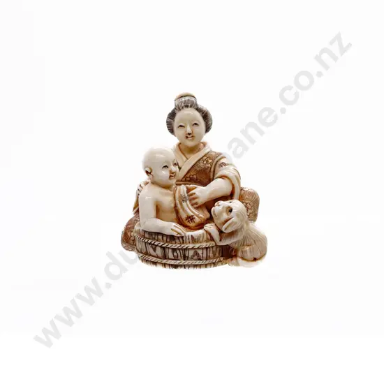 Signed and Stained Ivory Netsuke of a Mother Bathing a Child with Puppy Dog