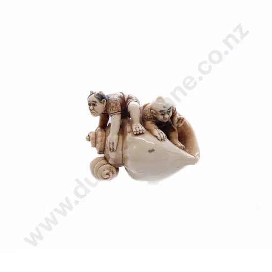Signed and Stained Ivory Netsuke of a Two Demons on an Giant Conch Shell