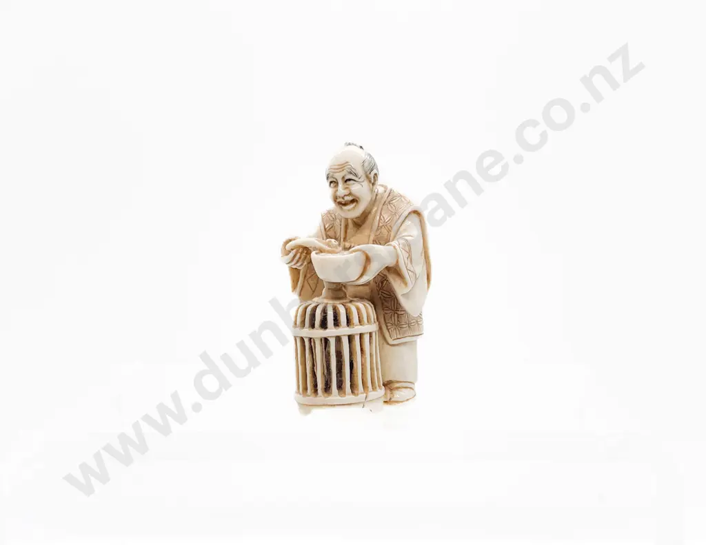 Signed and Stained Ivory Netsuke of a Trader with Basket of Quail Eating Soup Image 1++