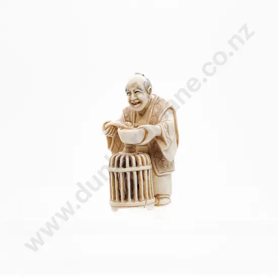 Signed and Stained Ivory Netsuke of a Trader with Basket of Quail Eating Soup