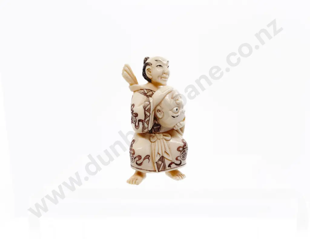 Signed and Stained Ivory Netsuke of a Actor Holding a Mask Image 1++