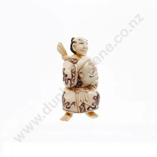 Signed and Stained Ivory Netsuke of a Actor Holding a Mask