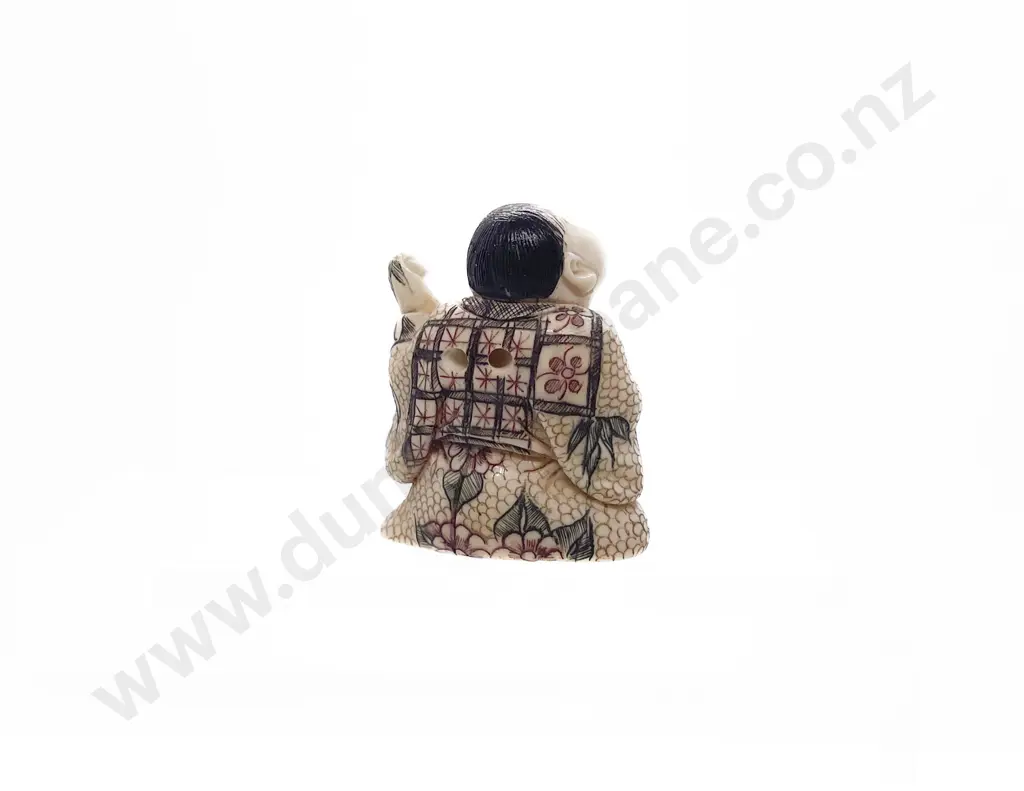 Signed and Stained Ivory Netsuke of a Seated Child Holding a Obi Hasami Image 1++