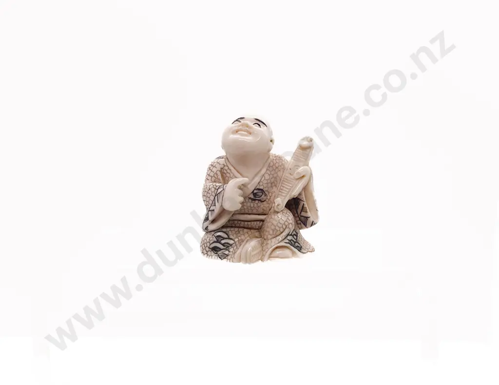 Signed and Stained Ivory Netsuke of a Seated Child Holding a Obi Hasami Image 1++