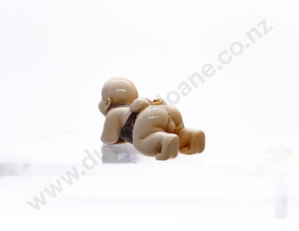 Signed and Stained Ivory Netsuke of a Male Child with MOP Inlaid Disc Image 1++