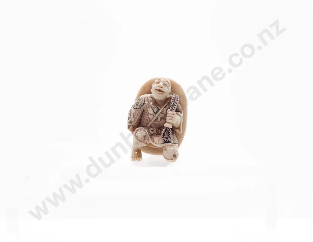Stained Ivory Netsuke of a Actor with Oversize Mask on His Back Image 1++
