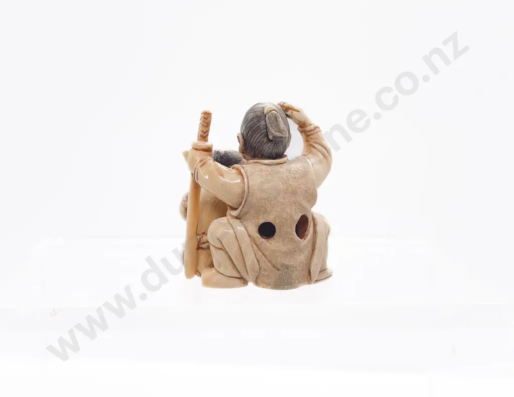 Signed and Stained Ivory Netsuke of a Old Samurai Seated with Apprentice and Rabbit Image 1++