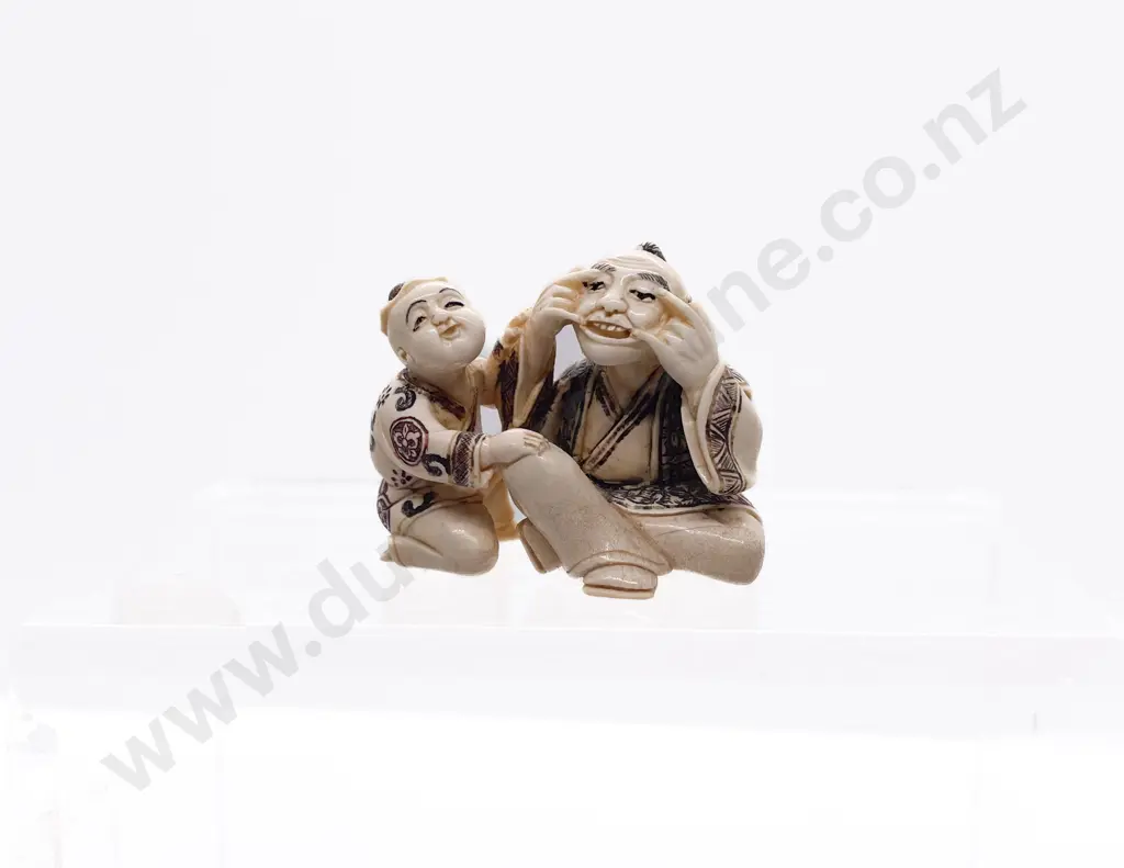 Signed and Stained Ivory Netsuke of a Grandfather Playing with His Grandson Image 1++