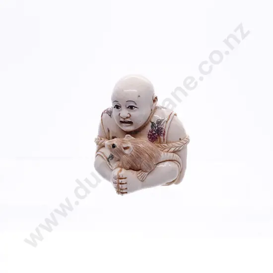 Stained Ivory Netsuke of a Young Boy Tried with Rope Rat on His Lap