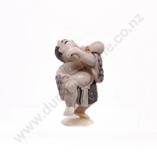 Signed and Stained Ivory Netsuke of a Man Drinking Water from a Gourd