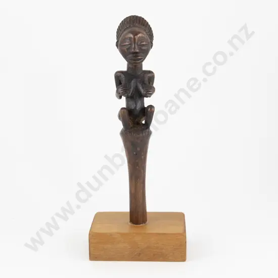 An African Fly Wisk Handle Mounted On A Wooden Base