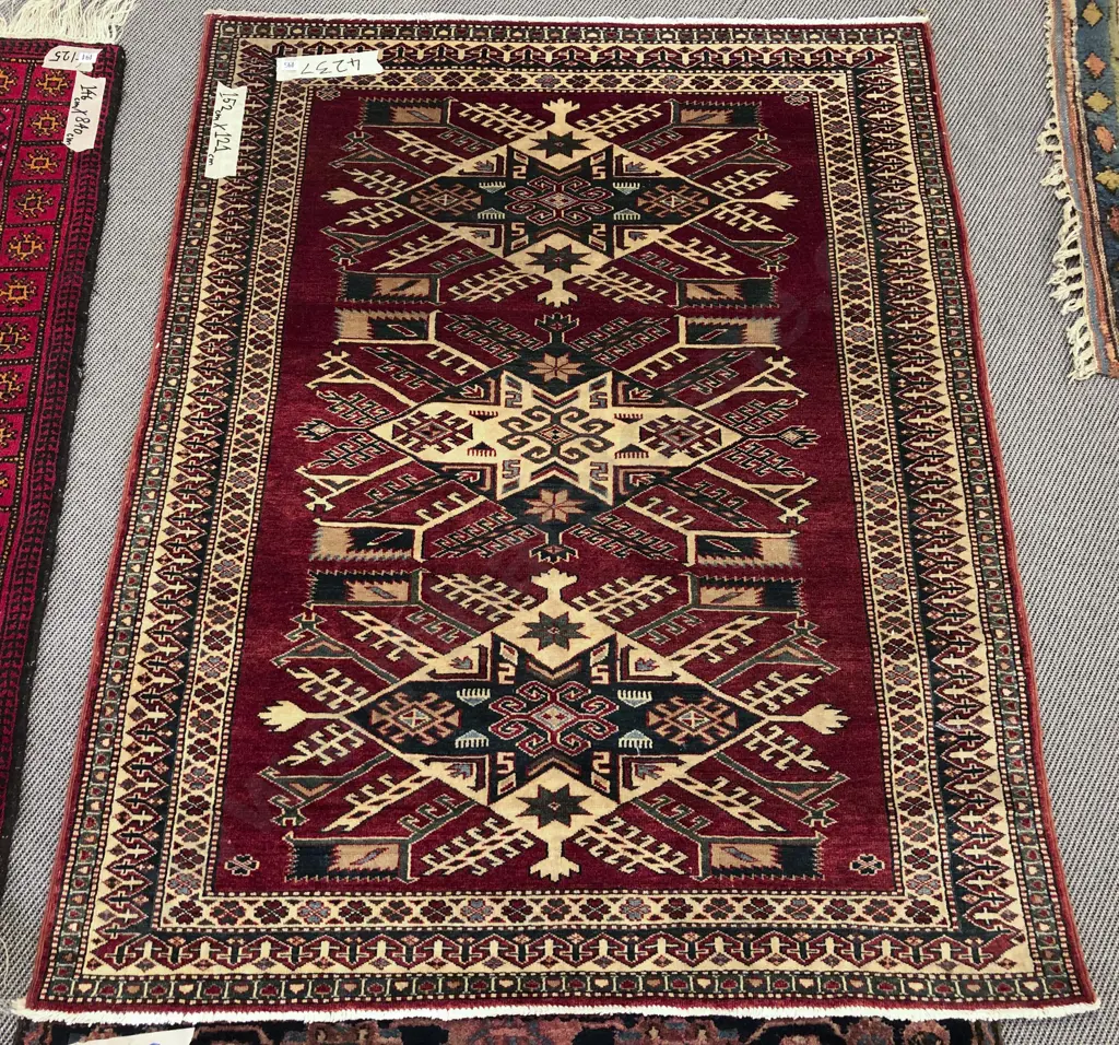 Persian rug with Three Central Lozenge Shaped Medallions On a Red Ground Image 1++
