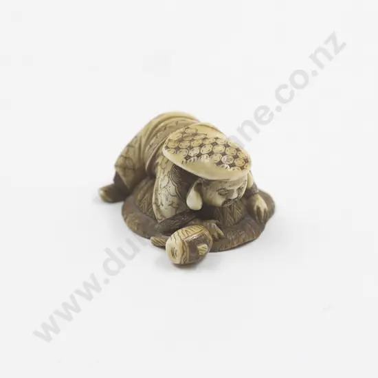 Japanese Ivory Netsuke Of A Man With A Large Mallet On A Rock Pursing An Oni