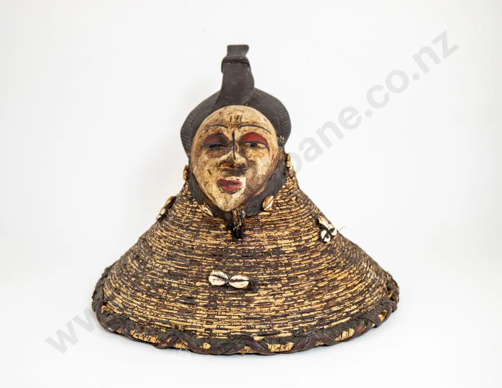 A Decorative African Mask Surmounting Painted Basketry With Cowrie Shells Image 1++