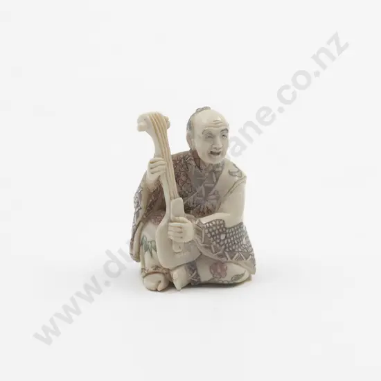 Signed and Coloured Pattern Ivory Netsuke of Musician playing a Shamisen