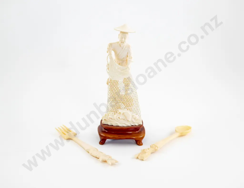 An Ivory Fisherman Holding A Net And An Ivory Fork And Spoon Image 1++
