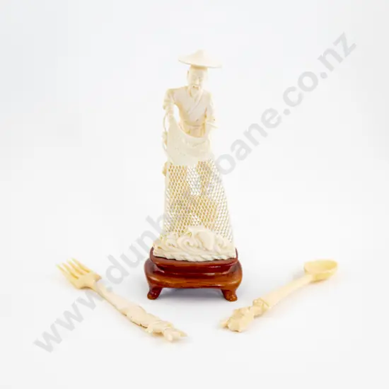 An Ivory Fisherman Holding A Net And An Ivory Fork And Spoon
