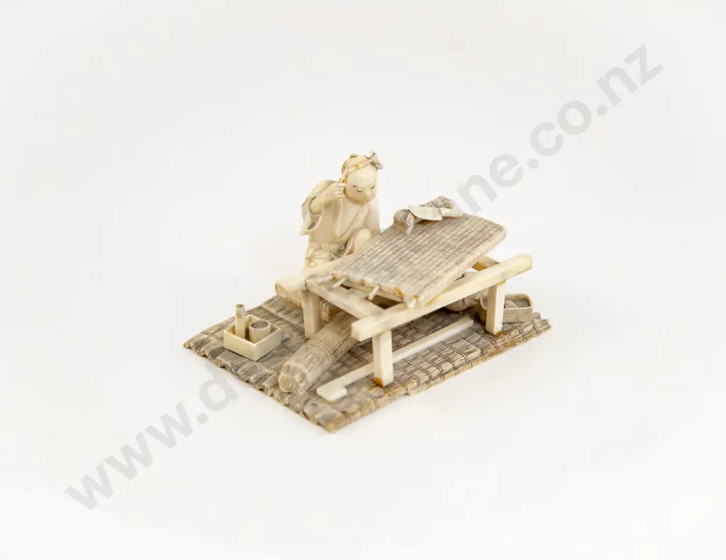 A Japanese Ivory Artisan Surrounded By Work Items Image 1++