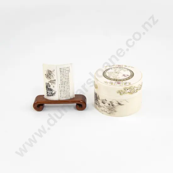 A Small Ivory Lidded Box With An Ivory Scroll Ornament On Wooden Base