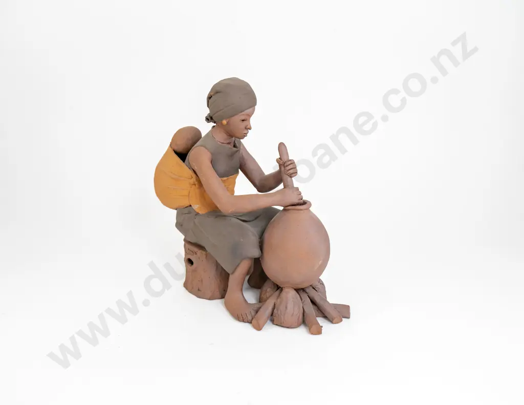 An Ceramic Sculpture Of An African Women Working Image 1++