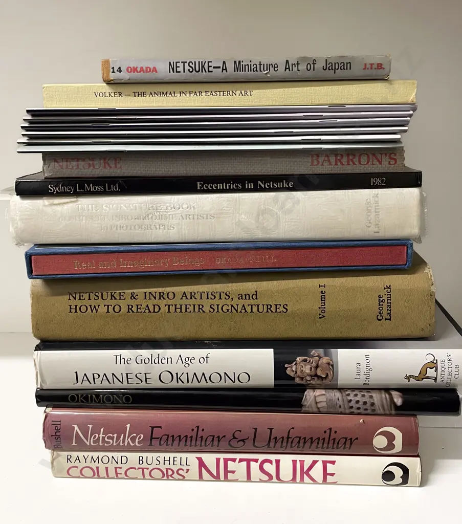 A Group Of Books On Netsuke Image 1++