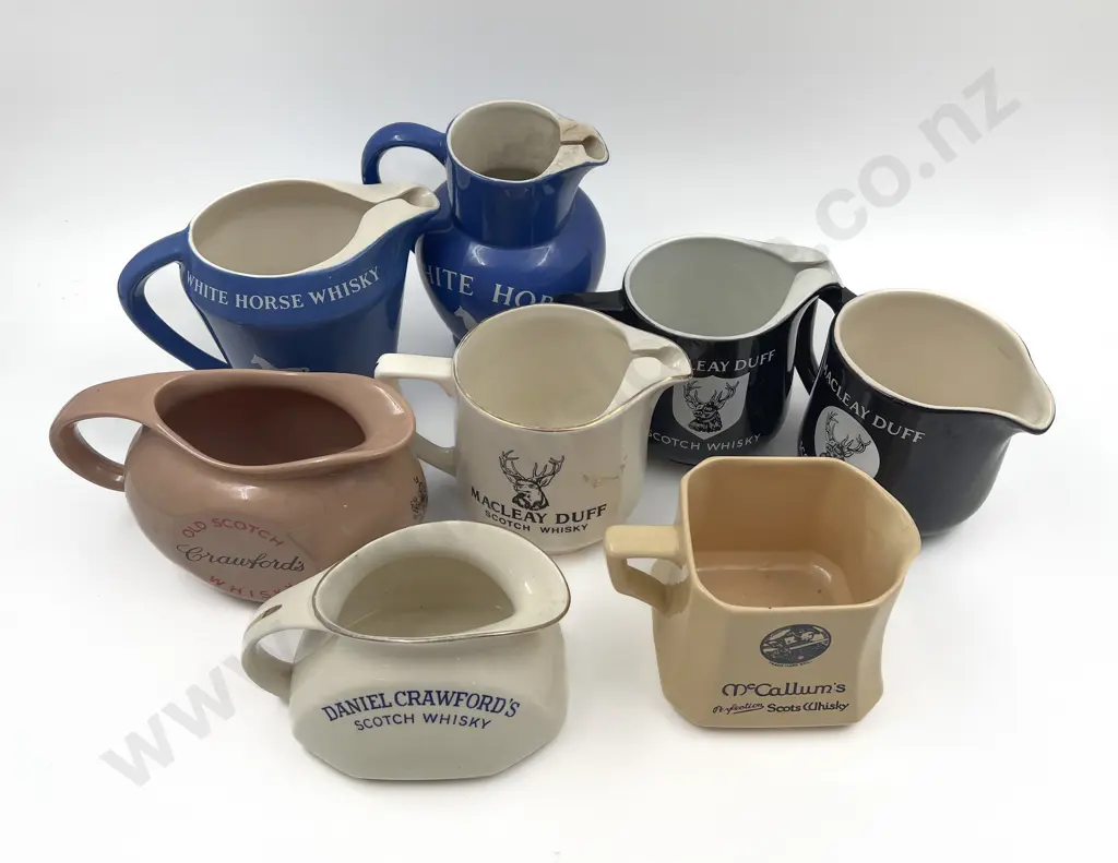 Eight Assorted Whisky Advertising Jugs Image 1++