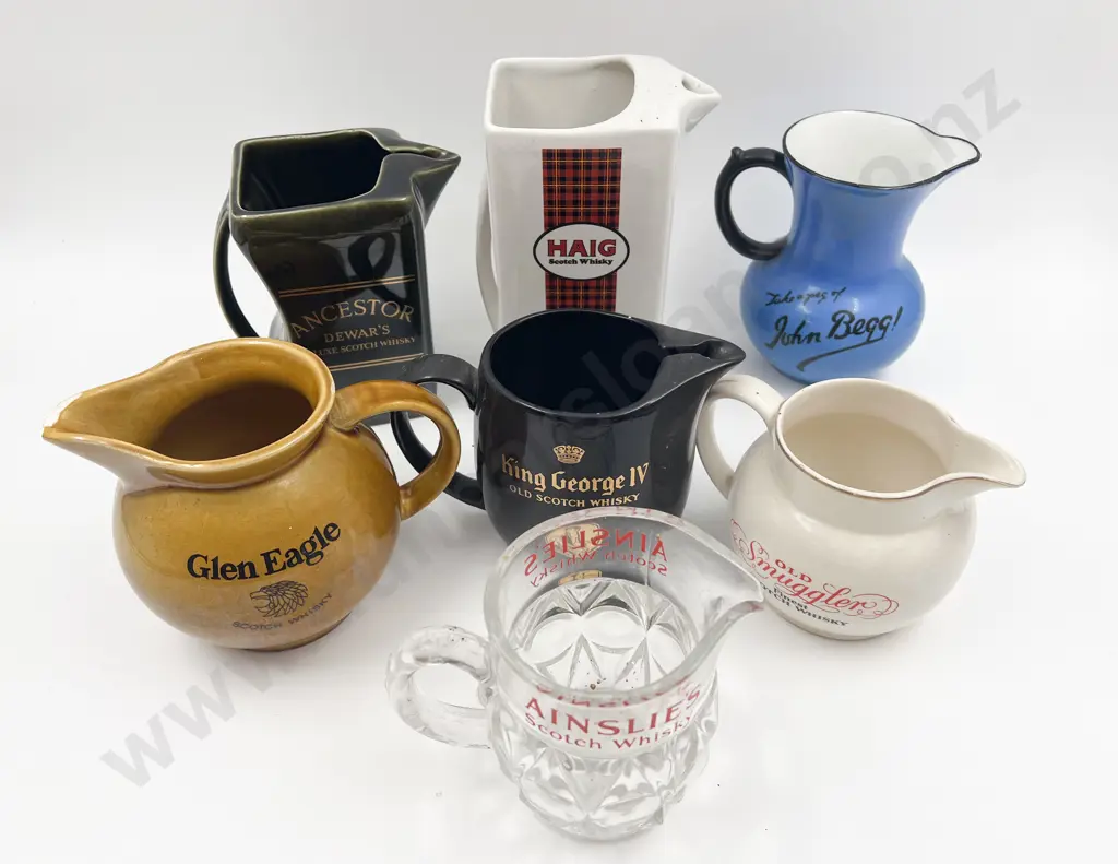 Seven Assorted Whisky Advertising Jugs Image 1++
