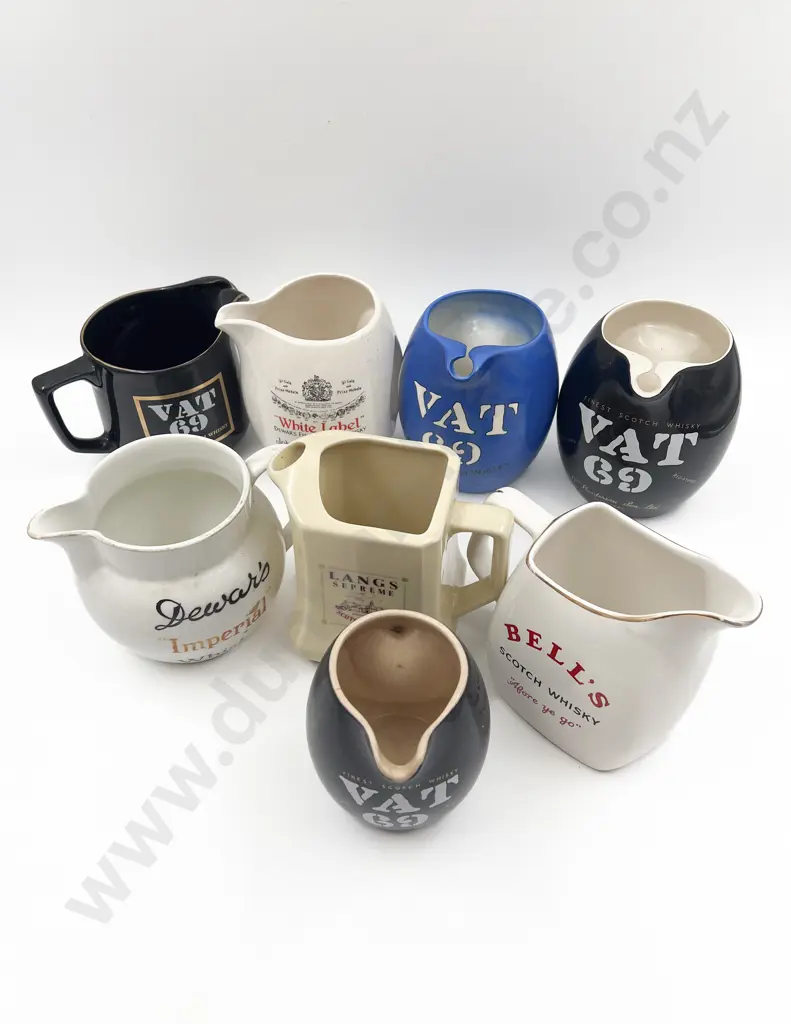 Eight Assorted Whisky Advertising Jugs Image 1++