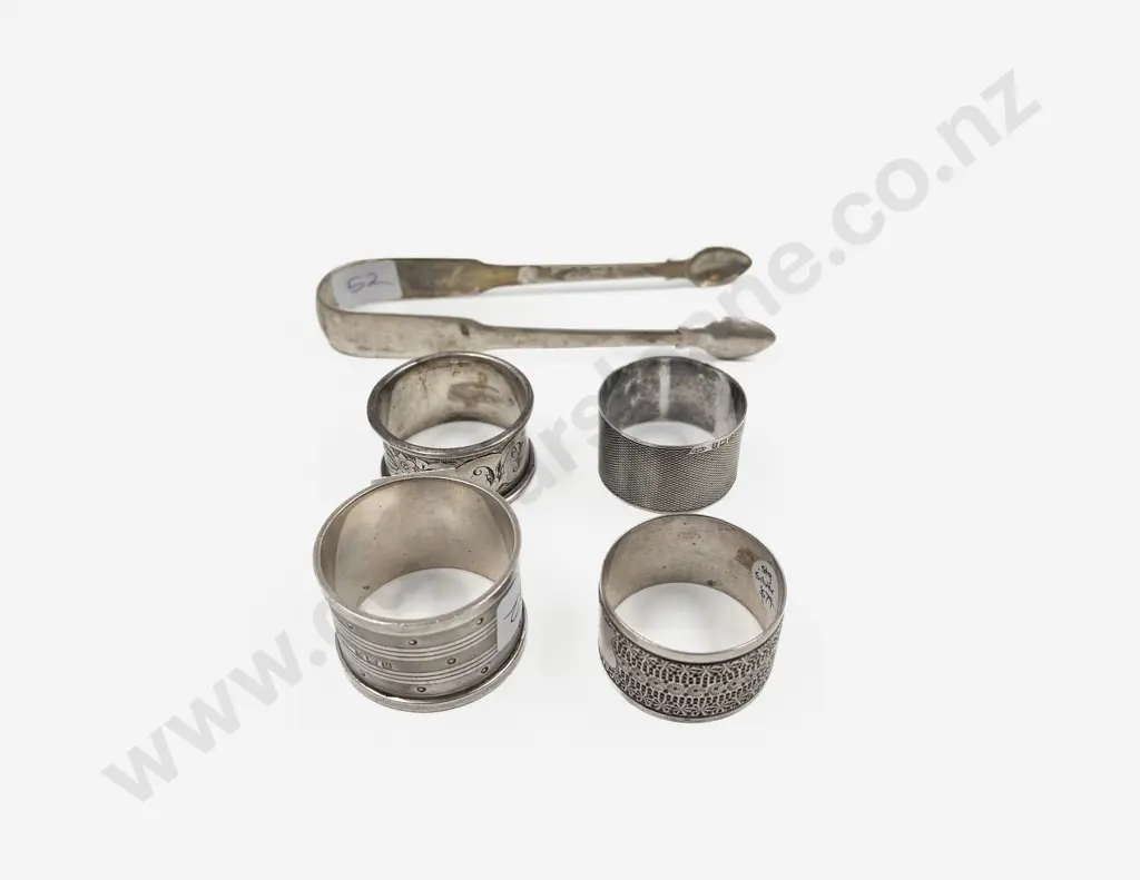 Four S/S Serviette Rings together with S/S Sugar Tongs Image 1++