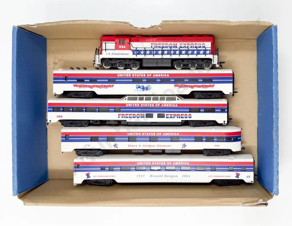 Unmarked and Unboxed Co-Co Diesel Loco and Four USA Freedom Express Coaches Image 1++