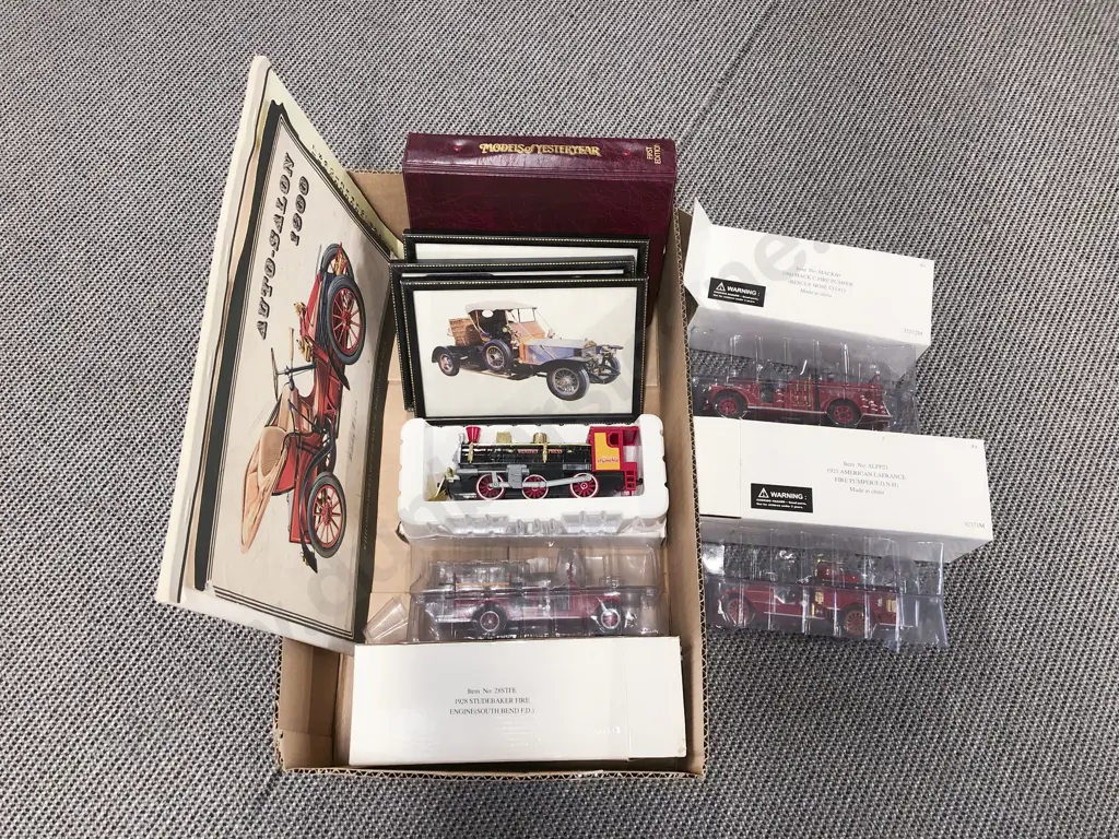 Four Boxed Fire Engine Models with Vintage Artwork and Reference Folder Image 1++
