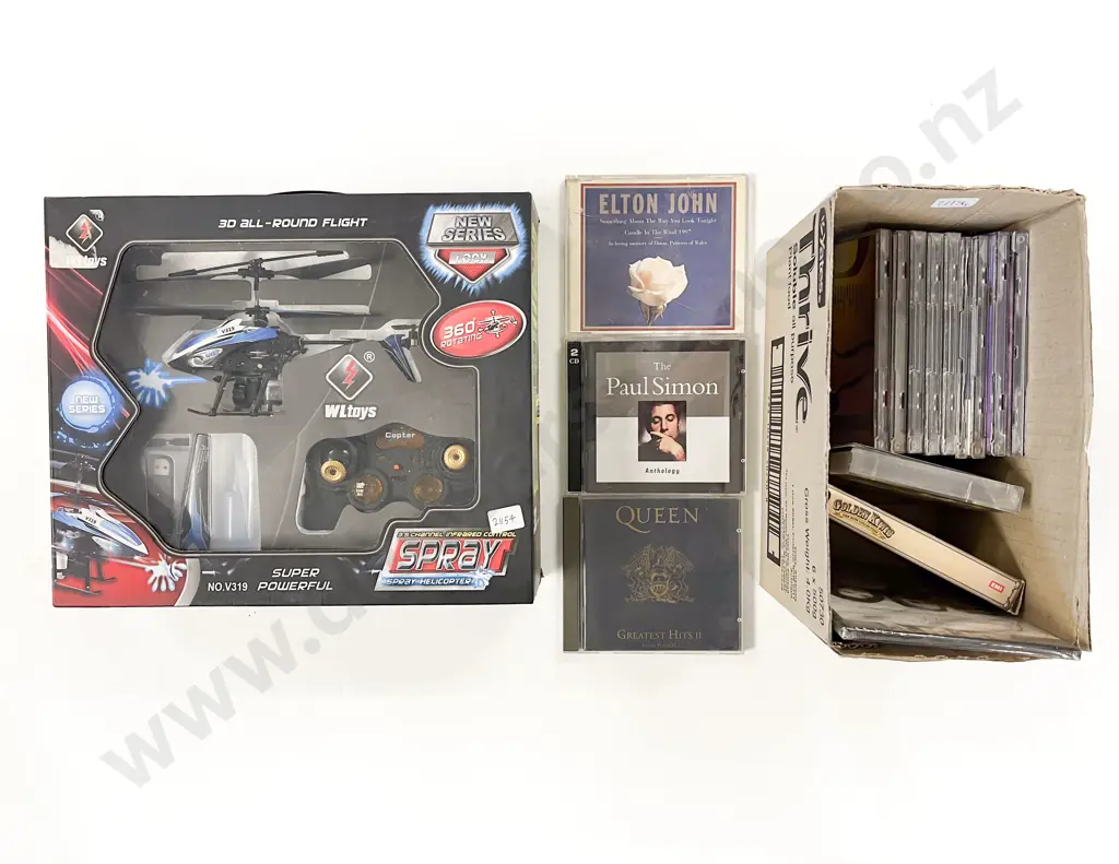 Boxed RC Helicopter together with Small Box of CDs Image 1++