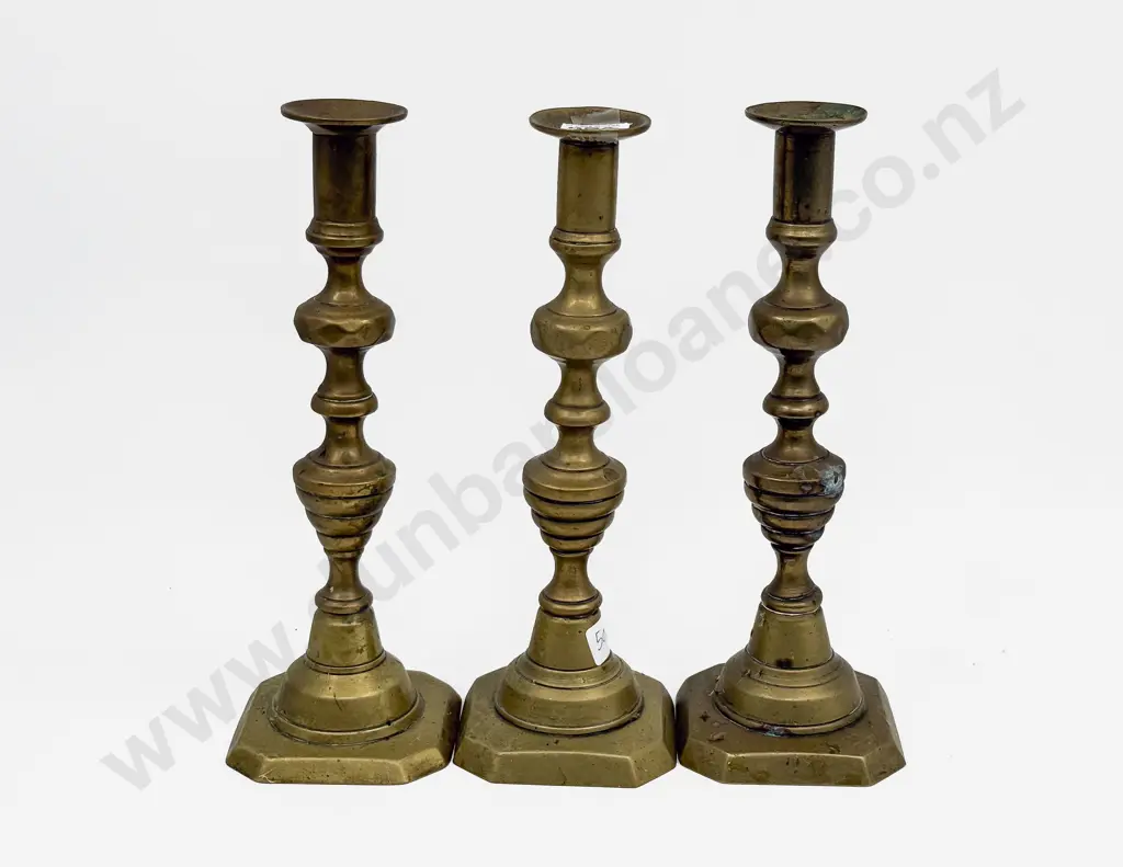 A Set of Three Brass Candlesticks Image 1++